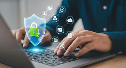 Naklejka premium A businessman is typing on a laptop with a digital shield and padlock representing cybersecurity and data protection