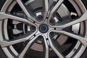Tire wheel steel rim and brake system of a luxury gray car, steel alloy gray rim