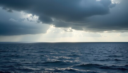 Obraz premium Serene Ocean View with Dramatic Cloudy Sky and Sunlight Breaking Through