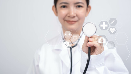A healthcare professional holds a stethoscope, showcasing digital health icons that symbolize...