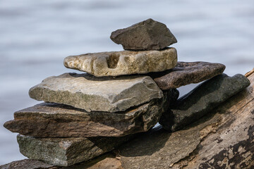 Stacked Stones on Driftwood by Water