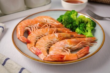 Boiled shrimp with Broccoli in ceramic plate on white background, clean meals