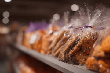 Bags of cookies on bakery shelf create warm, inviting atmosphere