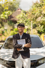 Car insurance agent in black suit and white shirt with car on background