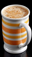 A mug with a striped design filled with a frothy beverage against a dark background