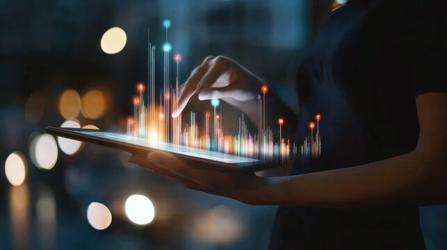 Businesswoman working on tablet with charts at night