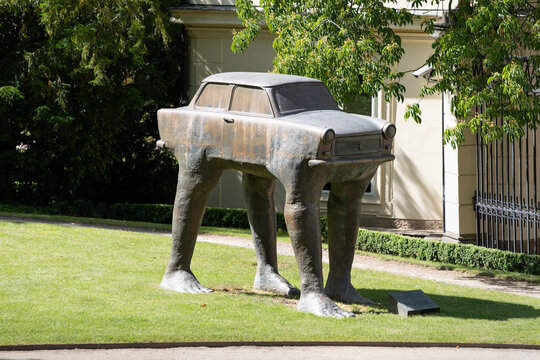 PRAGUE, CZECHIA - 29. May 2025: The walking Trabant "Quo vadis" in the garden of the German embassy. An artwork by David Čern&yacute;. Big bronze cast sculpture of a car standing on feet.