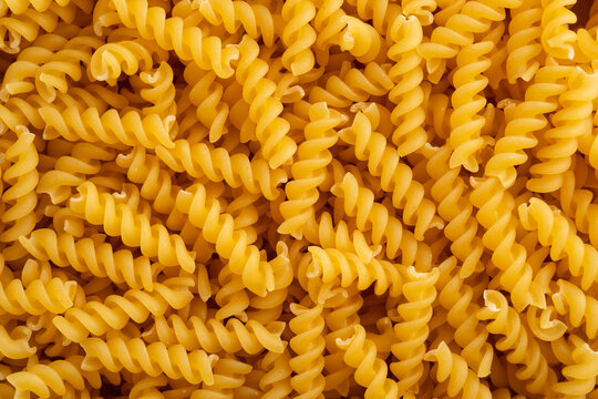 Uncooked dry Small Spirals pasta pattern for background.italian pasta. - Powered by Adobe