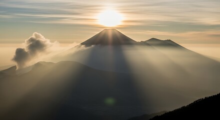 A majestic sunrise view over a mountain landscape, with sun rays piercing through clouds and mist creating a breathtaking natural moment.