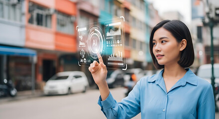 Young Asian professional interacts with AI on a transparent futuristic interface, illustrating innovative technology and data visualization.