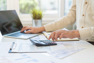 Account finance, asian young business man hand using calculator, laptop computer for calculate...