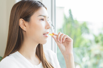 Dietary supplement, beautiful asian young woman, girl hand holding fish oil pills, drugs medical,...