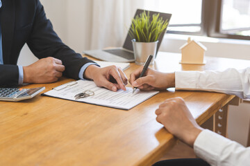 Asian landlord, realtor man pointing on paper for sign signature contract with tenant rental or...