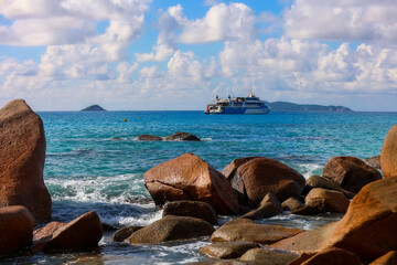 Scenic view of the coast with a ship and rocky shore