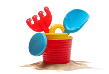 Set plastic garden toy for kids, watering can, shovel and rake in sand isolated on white background