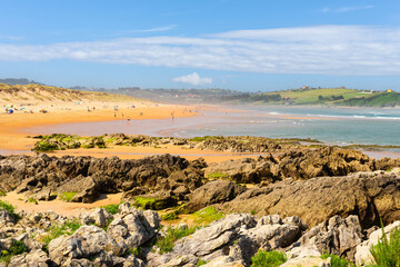 Liencres beach full of bathers on a sunny summer day, northern Spain, Santander, Cantabria.