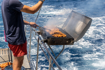 Meat and chicken are grilled on the stern of the Kaş, Kekova, and Kaleköy tour boat. The blue and sparkling sea is in the background.