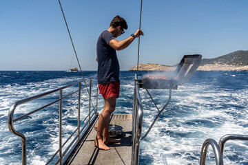 Meat and chicken are grilled on the stern of the Kaş, Kekova, and Kaleköy tour boat. The blue and sparkling sea is in the background.