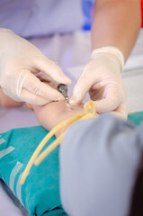 Close up nurse pricking needle syringe in the arm patient drawing blood sample for blood test , Health check