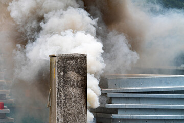Heavy smoke emerging from a power distribution box – possibly caused by a technical fault or...