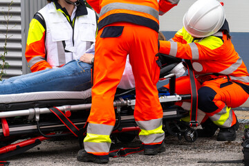 Rescue personnel prepare the transport of an injured person – professional care on-site.