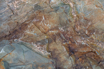 Rugged rock formation in natural outdoor setting during daytime, full-frame closeup