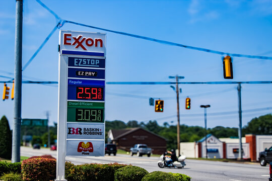 An Exxon gas station sign at a roadside commercial area in Maryville, TN with other buildings and traffic signals visible (July 2025). For Editorial Use.