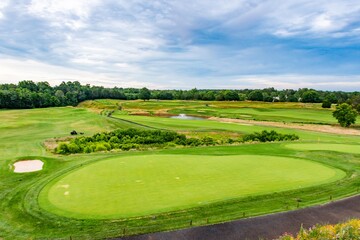 Panoramic shot of a picturesque golf course in Charlottesville, VA. Emphasizes the strategic layout...