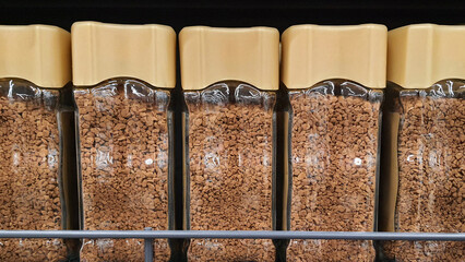 Glass jars of instant coffee filling a supermarket shelf