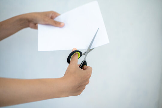 hand holding scissors white background isolated