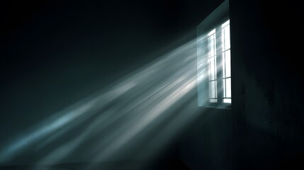 Sunbeams stream through window in a dark room creating light and shadow