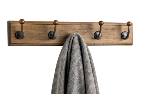 Rustic wooden coat rack with four hooks holding a folded blanket isolated on transparent background