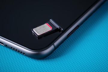 Sim card lying on a dark smartphone.