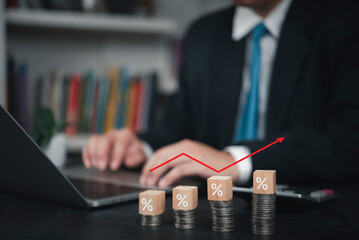 Professional working on computer, with visual of growing percentages and red arrow, symbolizing investment opportunity, high returns, financial tax planning, increasing income.