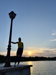 Woman gazing at sunset from a height