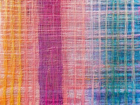Vibrant textile fabric with colorful woven pattern, featuring a blend of pink, blue, and orange hues for creative design.