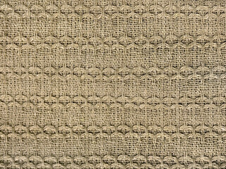 Gold beige knitted nylon fabric in random diamond and stripes pattern texture. Seamless golden...