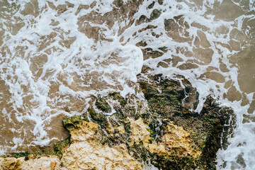 Textured tidal rocks beneath transparent seawater