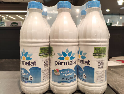 Rome, Italy - July 13, 2025: Parmalat milk bottles with vitamin D displayed on a store shelf, showcasing eco-friendly packaging and branding in a retail environment