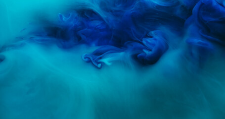 Blend flow. Atmospheric smoke. Defocused blue color ink in water fume swirling fog pigment...
