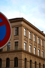 No parking road sign with a red border and blue center is prominently displayed in front of...