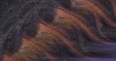 Sparkling texture. Splash liquid. Defocused golden purple color paint chemical splash pigment...