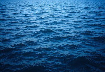 The deep blue sea is rippling with gentle waves, creating a mesmerizing abstract pattern