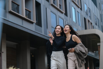 Two young businesswomen walking and talking in the city center