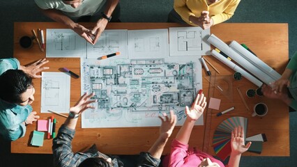 Top down aerial view of skilled civil engineer talking about building construction while standing...