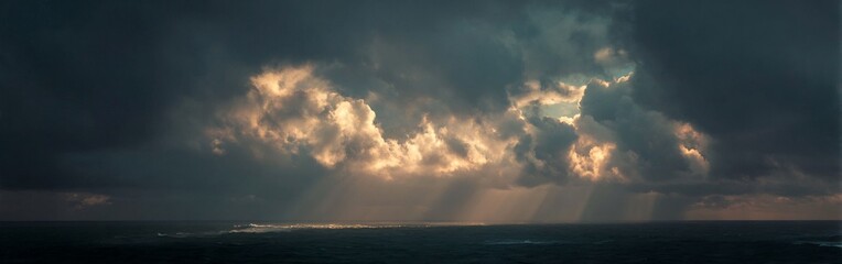 Fototapeta premium Dramatic ocean panorama showcasing sunlight filtering through stormy clouds creating a surreal