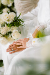 bride and groom hands with wedding rings