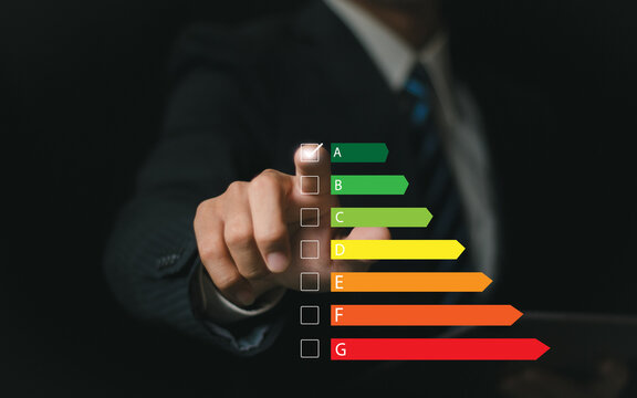 Home Improvement concept, Home Energy Efficiency, Eco-Friendly Home Improvement, Cost Savings and Green Energy Costs. businessman who chooses to use green energy saving in home - Powered by Adobe