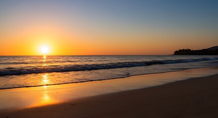 Obraz premium Serene beach sunset with golden light reflecting on tranquil ocean waves and wet sand