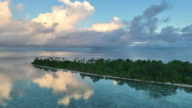 An idyllic, tropical island is surrounded by serene seas in Wakatobi National Park, Indonesia. This scenic area is a popular destination for divers and snorkelers due to high marine biodiversity.